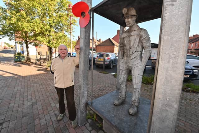 Ian Greig poses next to some public art that pays respect to the areas mining heritage.