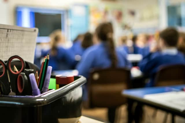 An out of focus photo of children in a classroom