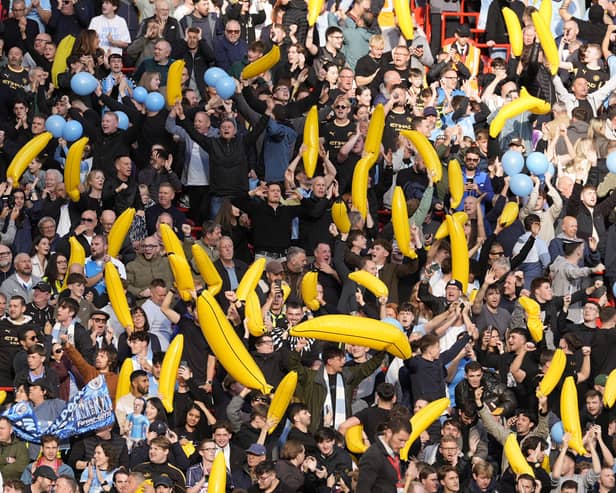 Manchester City fans hold up inflatable bananas at Anfield