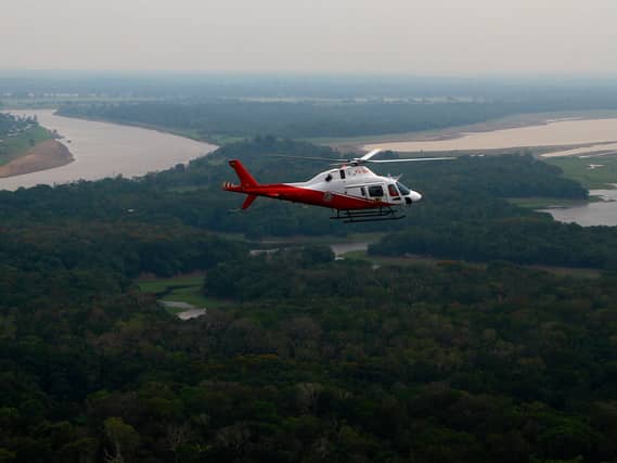 A helicopter from Brazil’s environmental agency flies over an area of the Amazon rainforest