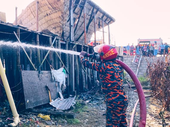 Firefighter sprays ruins