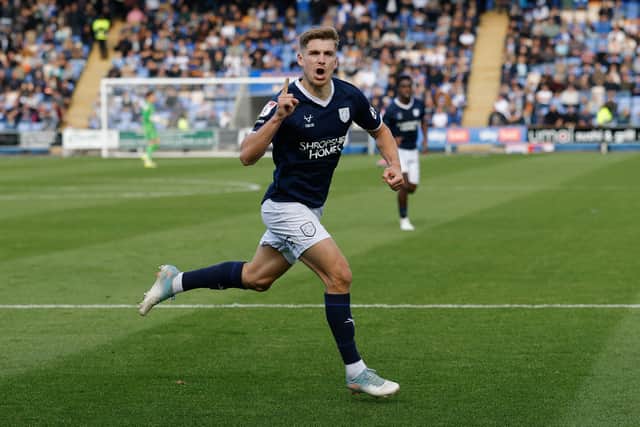 George Lloyd of Shrewsbury Town celebrates after scoring a goal to make it 1-0