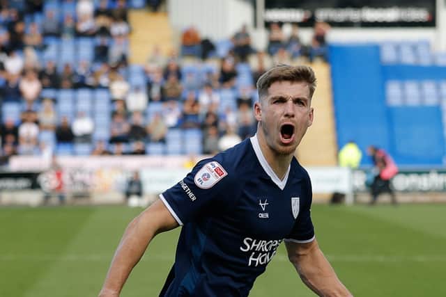 George Lloyd of Shrewsbury Town celebrates after scoring a goal to make it 1-0