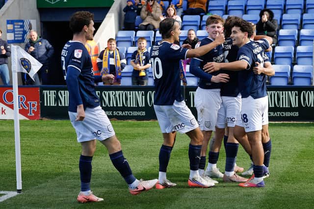 George Lloyd of Shrewsbury Town celebrates with his team mates after scoring a goal to make it 1-0