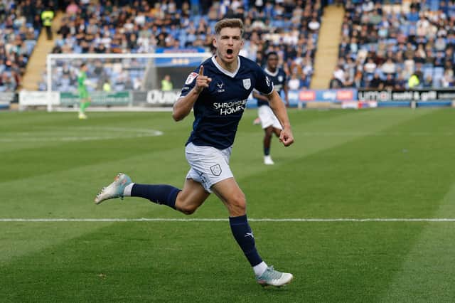 George Lloyd of Shrewsbury Town celebrates after scoring a goal to make it 1-0