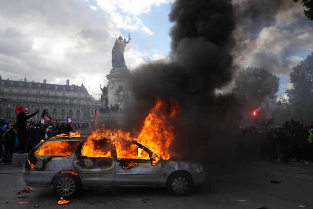 A car burns at Republique square in Paris (Thibault Camus/AP)
