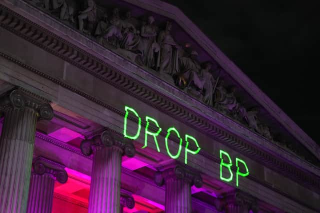 Protesters project ‘Drop BP’ onto the facade of the British Museum (Jeff Moore/PA)