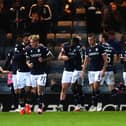 Callum Jones (second left) celebrates scoring