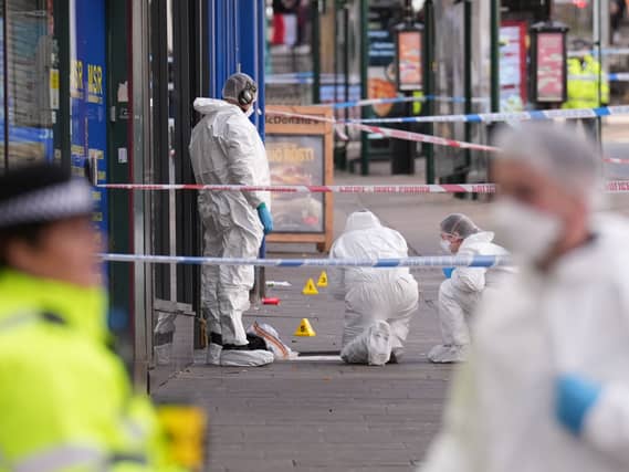 Forensic investigators at the scene on Angel Row in Nottingham, after a police officer was shot