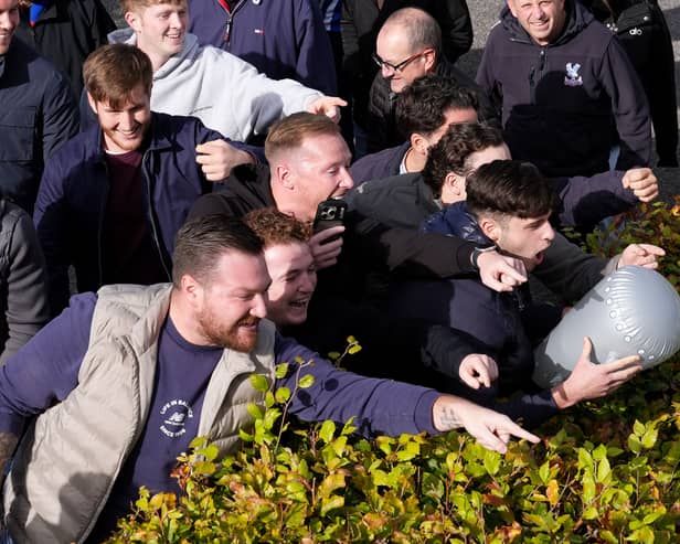 Crystal Palace fans gesture towards Brighton fans