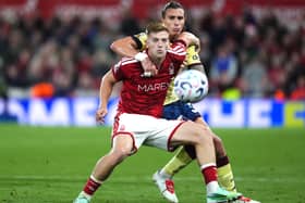 Nottingham Forest’s Liam Delap, left, and Arsenal’s Riccardo Calafiori battle for the ball