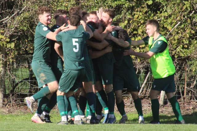 Ieuan Price is mobbed by his Radnor Valley team-mates after scoring