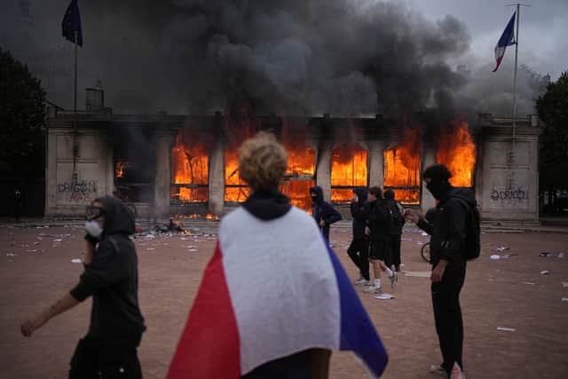 A tourism office was burned in Lyon during the protests (AP)