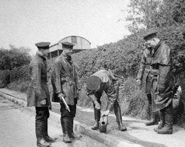 Members of Shrewsbury Borough Police Force in 1937, when policemen doubled as firemen. The location is possibly Bicton Heath and they appear to be checking a fire hydrant or piece of equipment. Left is Tom Davies, then Tom Meredith. Far right is Ieuan Lloyd. Jack Laird is thought to be the person bending down with “Bomber” Mills hidden second from right