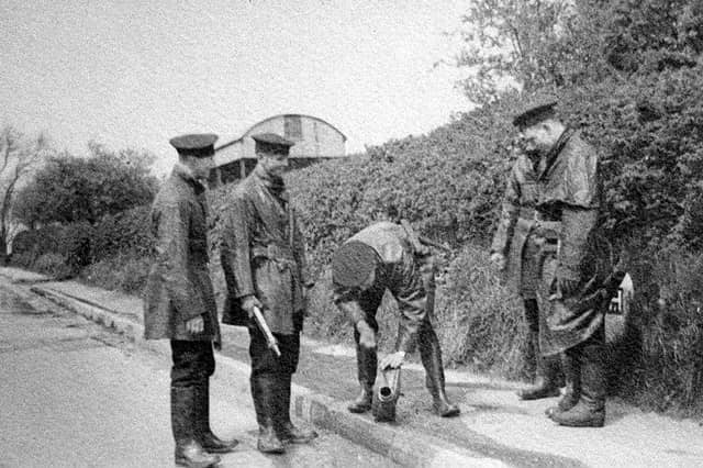 Members of Shrewsbury Borough Police Force in 1937, when policemen doubled as firemen. The location is possibly Bicton Heath and they appear to be checking a fire hydrant or piece of equipment. Left is Tom Davies, then Tom Meredith. Far right is Ieuan Lloyd. Jack Laird is thought to be the person bending down with “Bomber” Mills hidden second from right