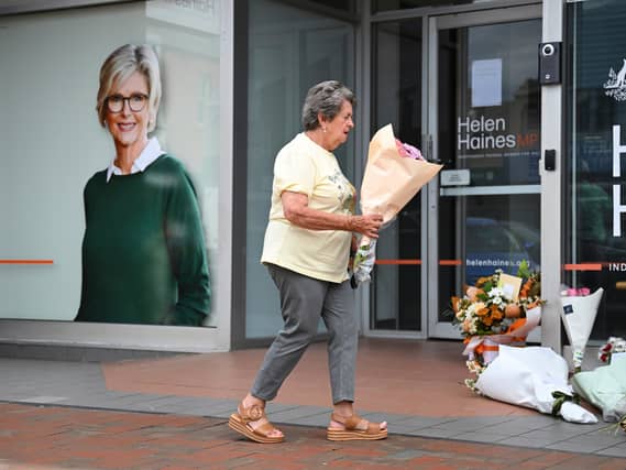 Someone lays flowers outside the MP's office