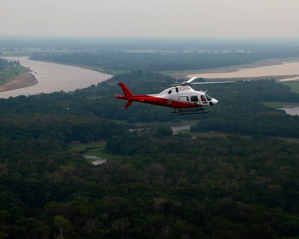 A helicopter from Brazil’s environmental agency flies over an area of the Amazon rainforest