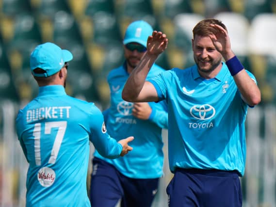 Gus Atkinson celebrates with team-mates after taking the wicket of Pakistan's Fakhar Zaman