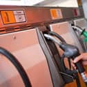 A person in hi-vis using a diesel pump
