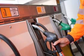 A person in hi-vis using a diesel pump