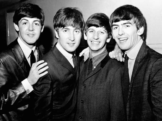 Black and white image of The Beatles in 1963