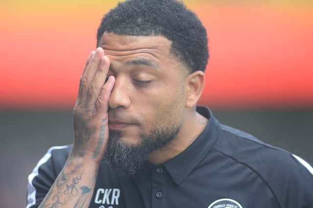 Crawley manager Colin Kazim-Richards puts a hand on his face in frustration