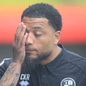 Crawley manager Colin Kazim-Richards puts a hand on his face in frustration