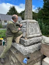 Stonemason Jonathan Protheroe working to restore Nantmel's war memorial to its best