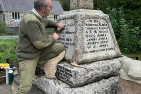 Stonemason Jonathan Protheroe working to restore Nantmel's war memorial to its best