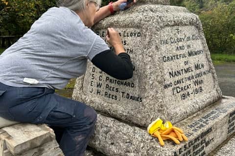 Ms Rebecca Twyman from Llangunllo helping to restore some of the black lettering