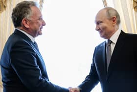 Russian President Vladimir Putin, right, greets US envoy Steve Witkoff