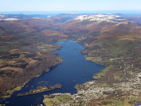 aerial view of Windermere in the Lake District, Cumbria, with snow capped mountains in the background,