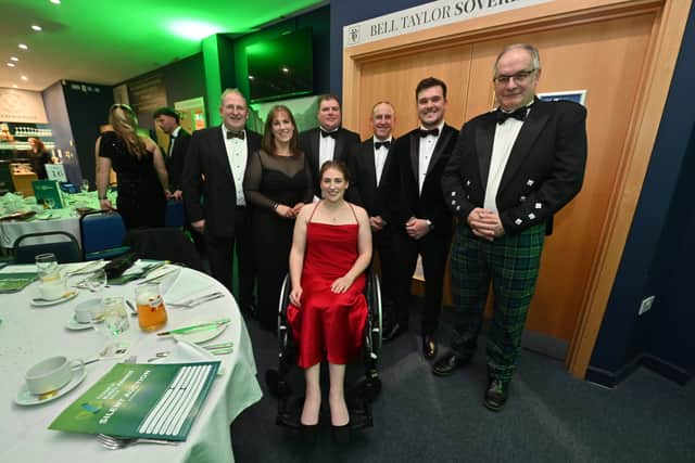 In the red dress is Annabelle Farmer with the team behind the Edwards & Farmer Ltd Charity Tractor Run.