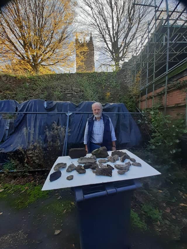 Martin Crowdy shows how much masonry had fallen off a wall near St Laurence's Church in Ludlow.