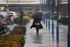 Shoppers get caught in the storm at Bentley Bridge, Wednesfield.
Tim Thursfield/Iconic Media Group


