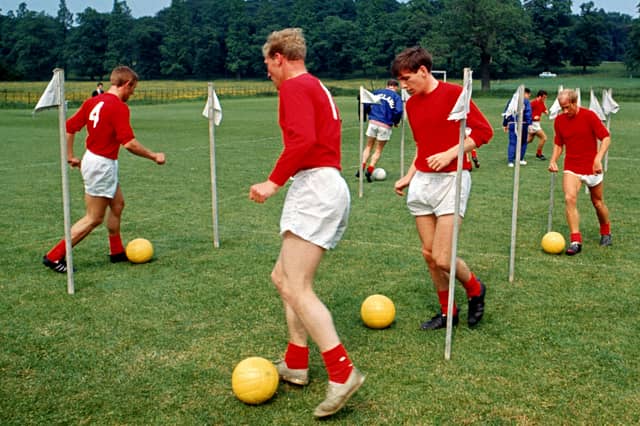 PICTURE FROM THE ARCHIVE: Members of England’s 1966 World Cup squad - Peter Thompson, Ron Flowers, Martin Peters, and Bobby Charlton, weave through slalom poles with footballs during an intensive training session at Lilleshall Hall in Shropshire. The national sports centre served as the quiet, secluded base where manager Sir Alf Ramsey put his squad through their paces ahead of their historic World Cup victory later that summer.