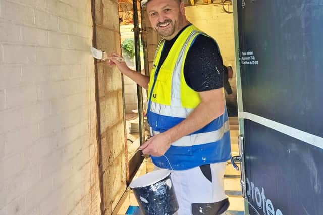 Telford College tutor Barry Mason gives a wall a lick of paint
