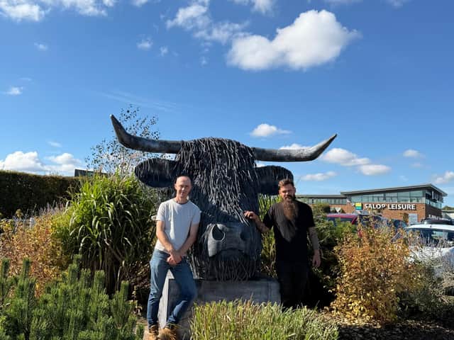 Nik Burns and Sam Drinkwater with Griff the Highland Cow outside Salop Leisure.