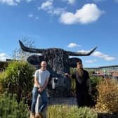 Nik Burns and Sam Drinkwater with Griff the Highland Cow outside Salop Leisure.