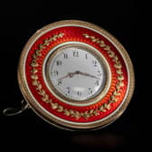 The Fabergé gold mounted and enamelled, circular table clock valued at up to £80,000.