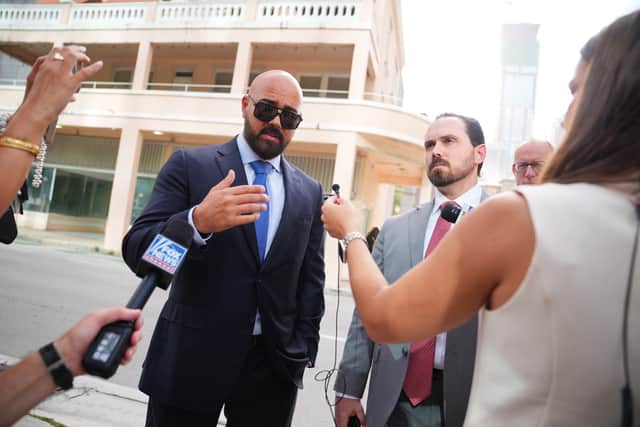 The Tates’ lawyers, Joseph McBride, left, and Thomas Maniotis, speak to the media outside court in Miami (James Manning/PA)