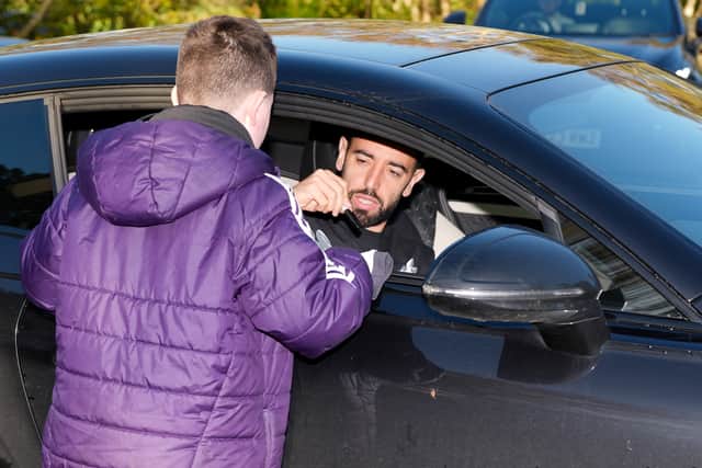 Bruno Fernandes signs an autograph as he arrives at Manchester United’s Carrington training ground (Annabel Lee-Lewis/PA).