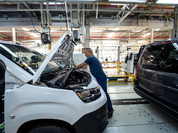 Workers and vans on an assembly line