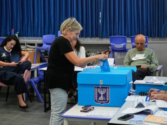 A woman casts her ballot at a polling station during Israel’s general election