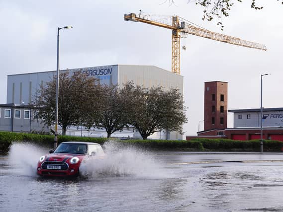 A car drives through floodwater