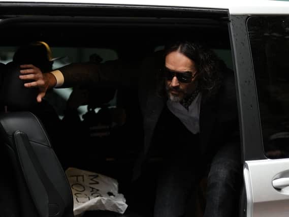 Russell Brand getting out of a car