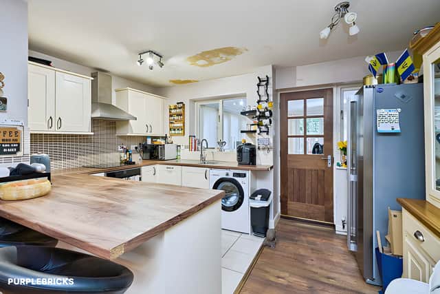 A refitted kitchen with integrated appliances, an under-counter fridge, dishwasher and spacious breakfast bar brings useful preparation and casual dining space to the home.