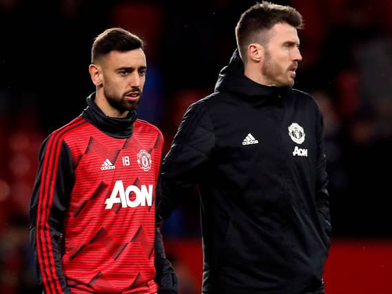Manchester United manager Michael Carrick (right) says Bruno Fernandes (left) will continue as captain
