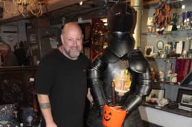 The suit of armour with a member of the antiques team