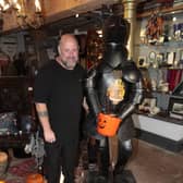 The suit of armour with a member of the antiques team